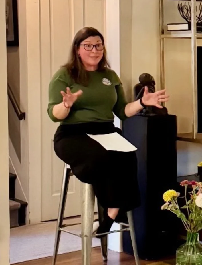 Meghann Reimondo speaking with supporters at a Woodstock house party